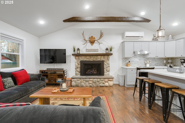 living room featuring a stone fireplace, dark hardwood / wood-style floors, lofted ceiling with beams, and a wall mounted air conditioner