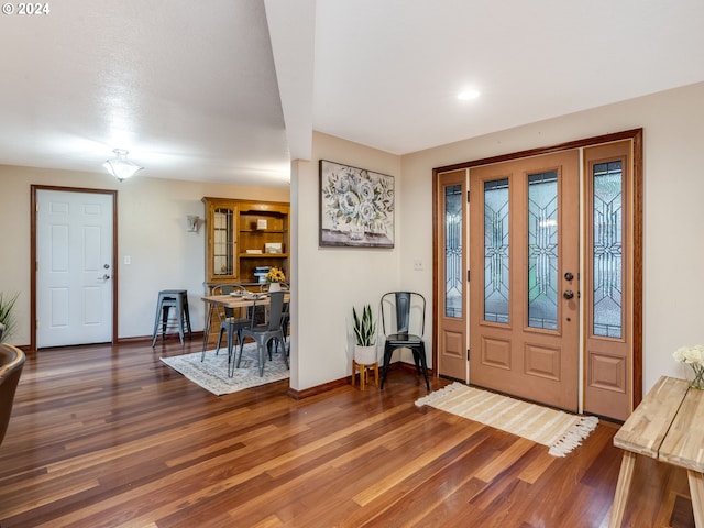 entryway with dark hardwood / wood-style floors