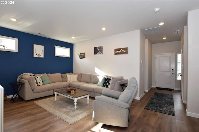 living room with a healthy amount of sunlight and dark hardwood / wood-style flooring