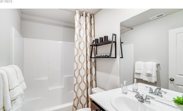 full bathroom with vanity, toilet, and shower / tub combo