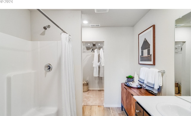 bathroom featuring vanity, hardwood / wood-style floors, and a shower with curtain