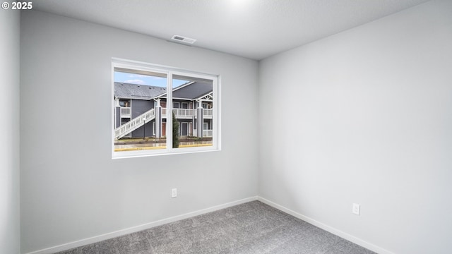 unfurnished room featuring carpet