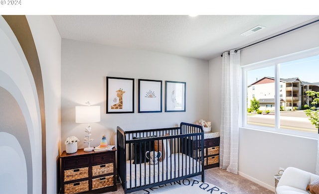 carpeted bedroom with a crib