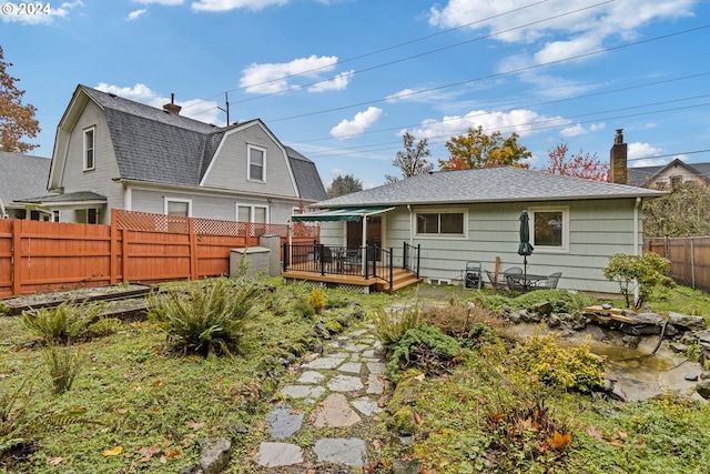 back of house featuring a deck