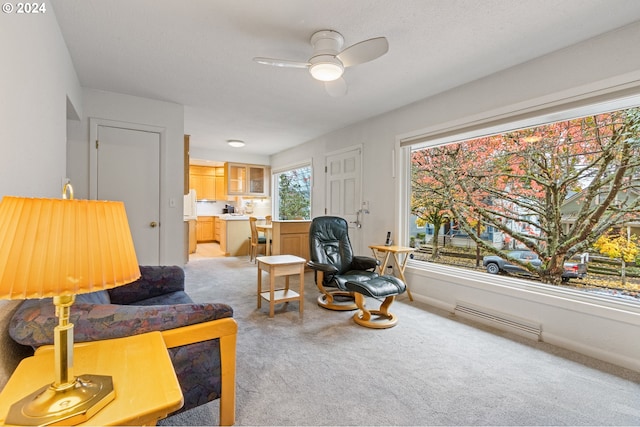 living room featuring light carpet and ceiling fan