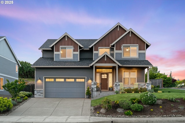 1010 NW 1st St, Dundee, OR 97115 - craftsman inspired home featuring a garage, a porch, stone siding, and concrete driveway