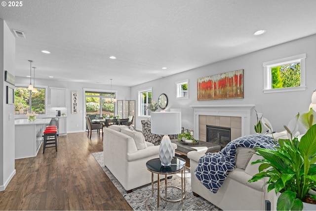 1010 NW 1st St, Dundee, OR 97115 - living room with a fireplace, baseboards, dark wood-type flooring, visible vents, and recessed lighting
