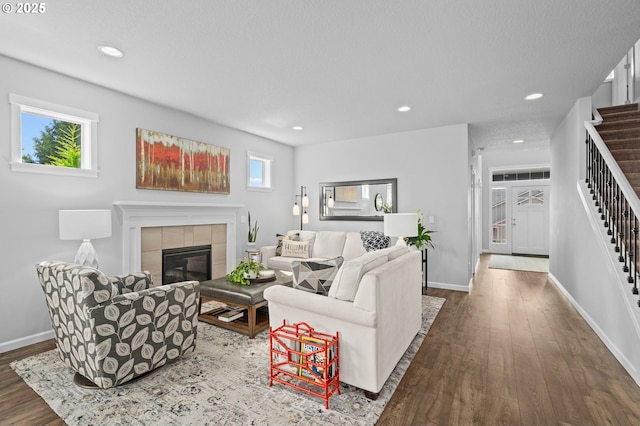 1010 NW 1st St, Dundee, OR 97115 - living area featuring stairway, a healthy amount of sunlight, wood finished floors, and a tiled fireplace