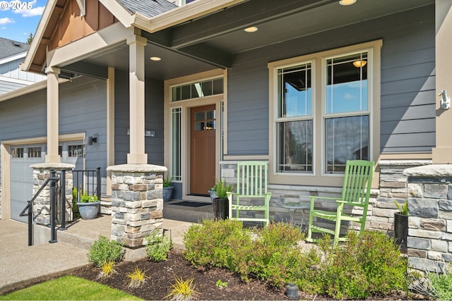 1010 NW 1st St, Dundee, OR 97115 - doorway to property with a porch, an attached garage, and stone siding