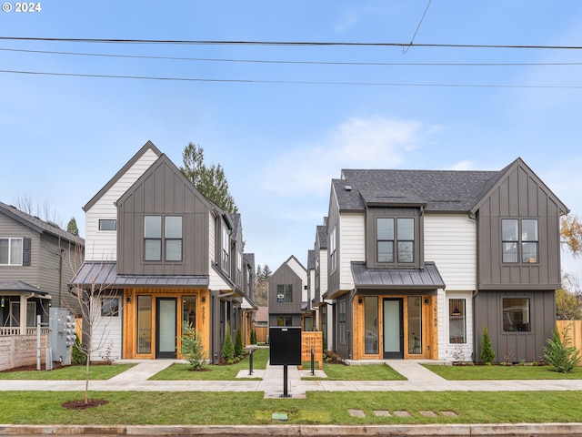 modern inspired farmhouse featuring a front lawn