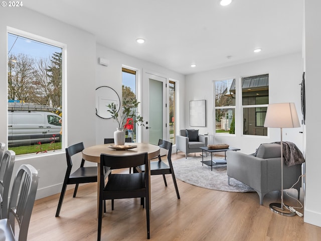 dining space with light hardwood / wood-style flooring