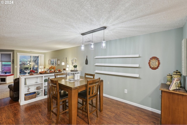 dining area featuring dark hardwood / wood-style floors and a textured ceiling