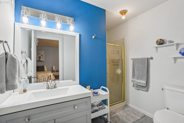 bathroom featuring toilet, an enclosed shower, and vanity