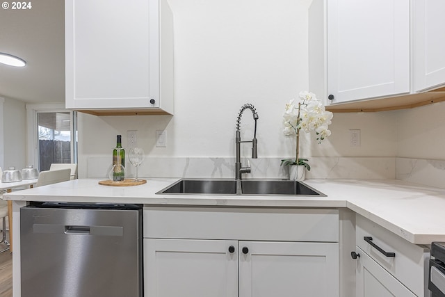 kitchen with sink, white cabinets, and stainless steel dishwasher