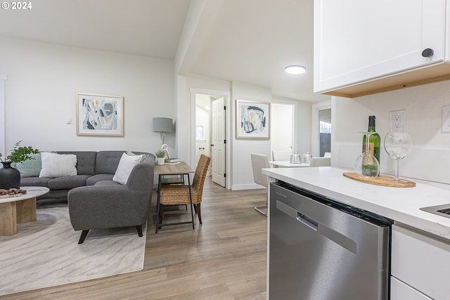 kitchen featuring white cabinetry, light hardwood / wood-style flooring, and stainless steel dishwasher