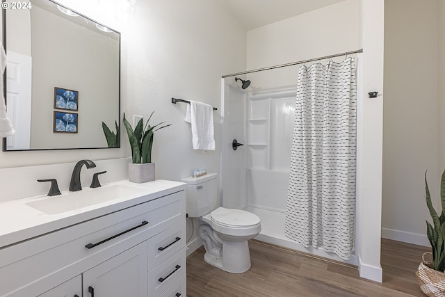 bathroom featuring a shower with curtain, toilet, wood-type flooring, and vanity