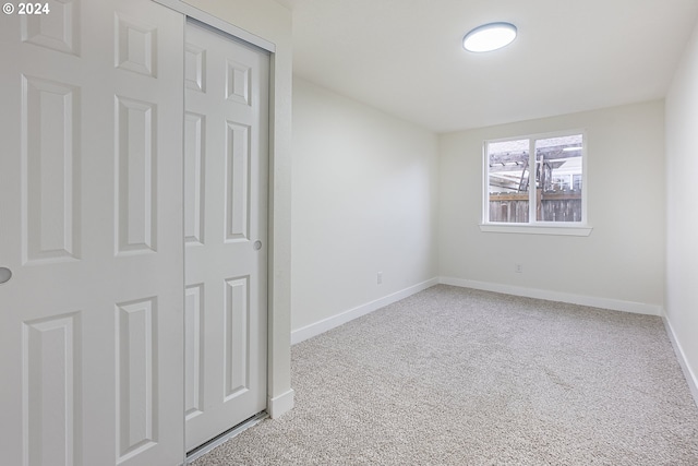 unfurnished bedroom featuring carpet and a closet