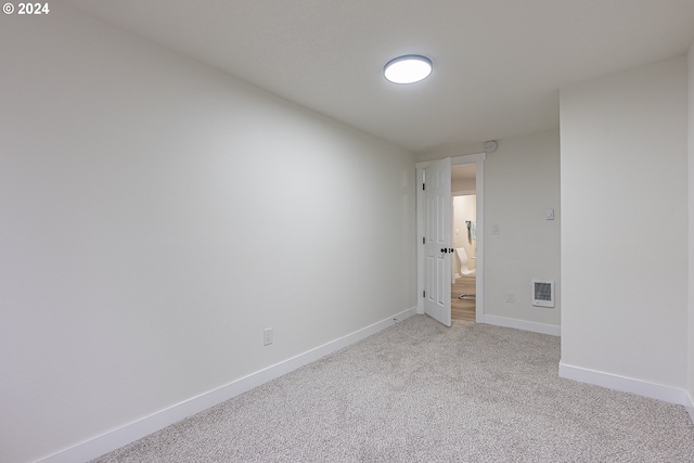 spare room with light colored carpet