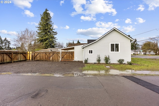 view of side of home featuring a carport