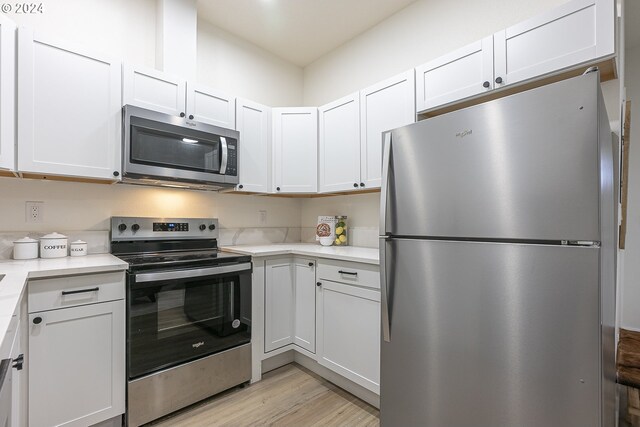 kitchen with white cabinetry and appliances with stainless steel finishes