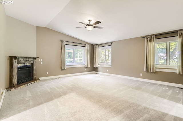 unfurnished living room with ceiling fan, carpet floors, and lofted ceiling