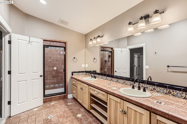 bathroom featuring decorative backsplash, lofted ceiling, vanity, and an enclosed shower