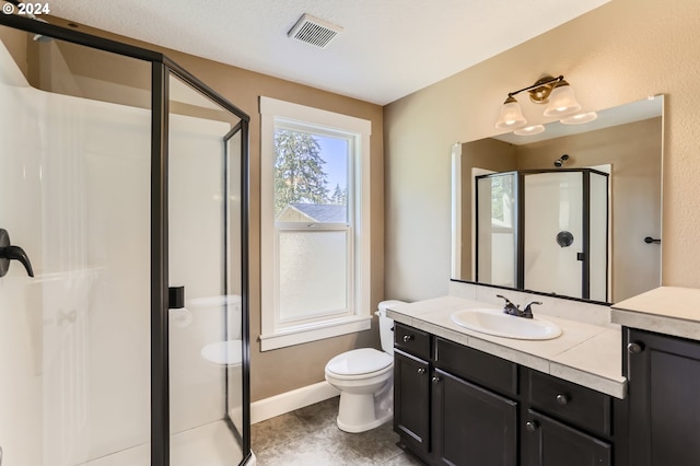 bathroom featuring vanity, toilet, and walk in shower