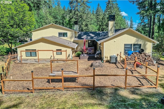 rear view of property with cooling unit