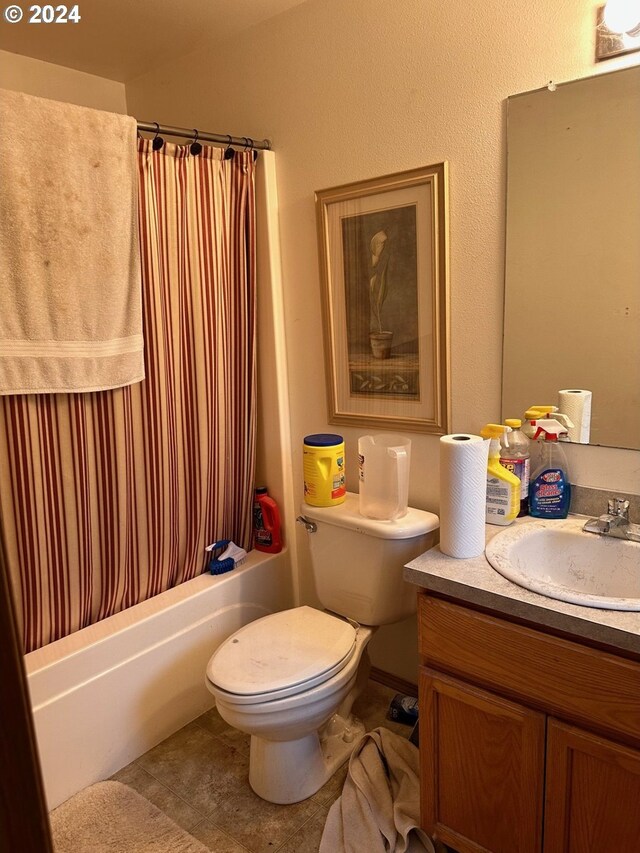 full bath featuring vanity, tile patterned flooring, shower / bath combination with curtain, and toilet