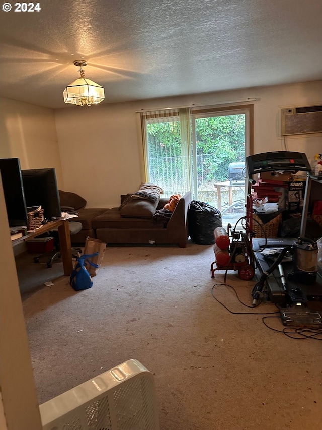 living area with carpet floors, an AC wall unit, and a textured ceiling