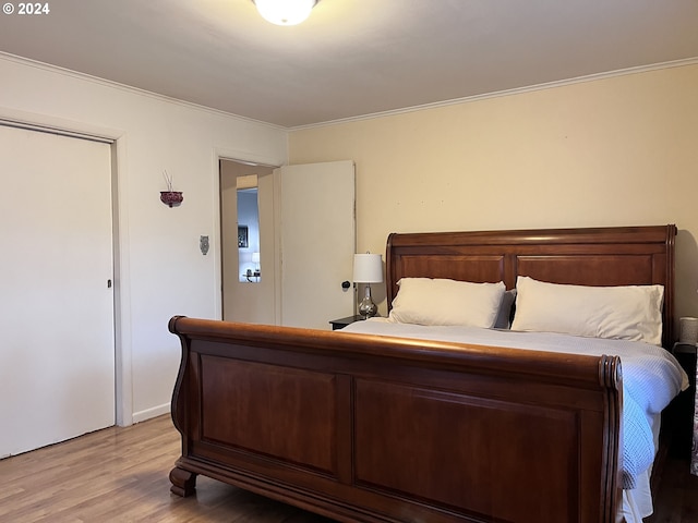 bedroom featuring light hardwood / wood-style floors and ornamental molding