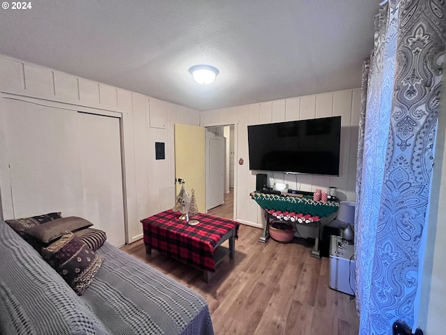 living room featuring light hardwood / wood-style flooring and a textured ceiling