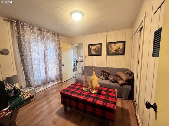 bedroom featuring hardwood / wood-style floors and a textured ceiling