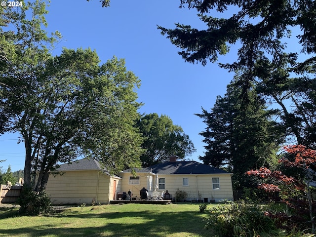 rear view of house with a yard