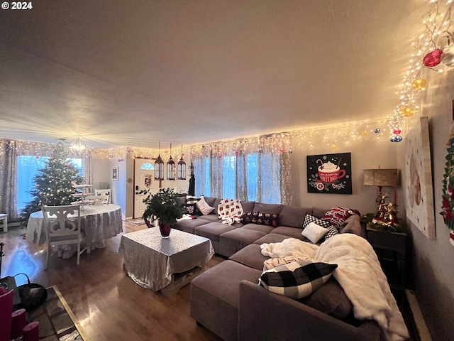 living room featuring hardwood / wood-style flooring and an inviting chandelier