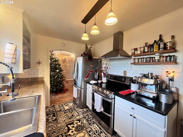 kitchen featuring decorative backsplash, stainless steel appliances, dark wood-type flooring, wall chimney range hood, and white cabinetry