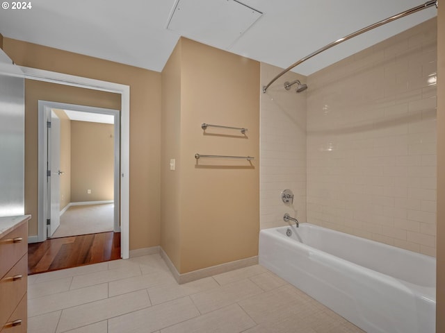 bathroom with vanity, tiled shower / bath combo, and hardwood / wood-style floors