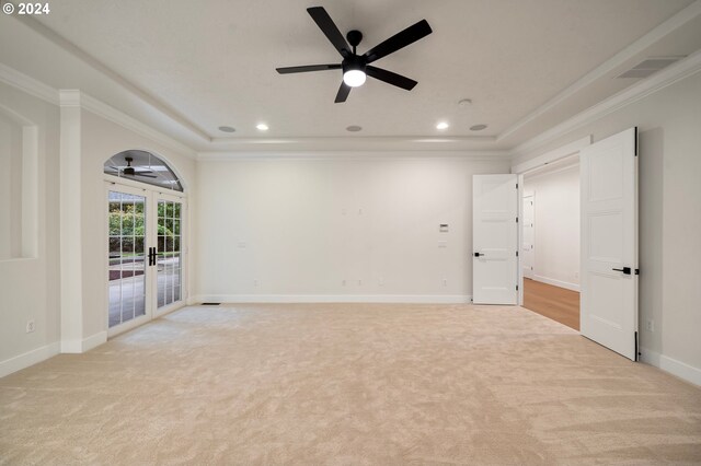 spare room with light colored carpet, french doors, and crown molding