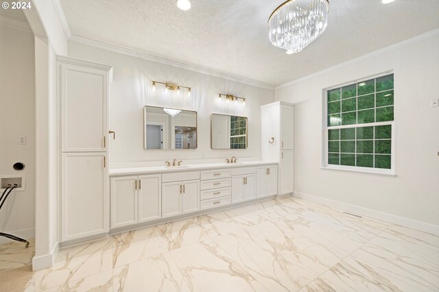 bathroom with a textured ceiling, crown molding, baseboards, and a sink