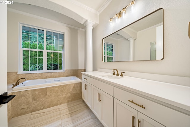 bathroom with decorative columns, a bath, plenty of natural light, and ornamental molding