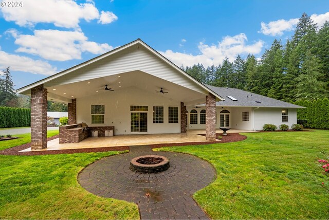 rear view of property featuring french doors, a lawn, and a patio area