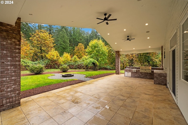 view of patio / terrace with a fire pit, area for grilling, and a ceiling fan