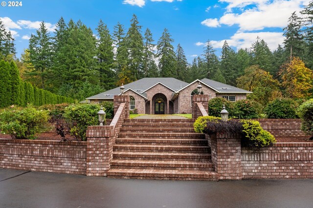 view of front of home with stairway and a fenced front yard