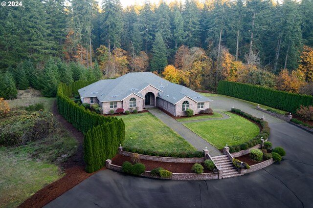 birds eye view of property featuring a view of trees