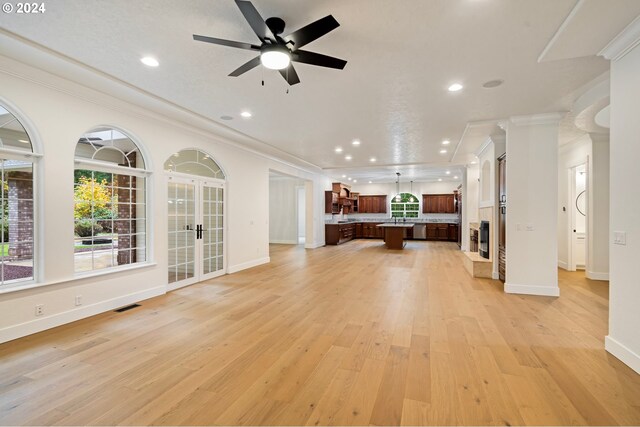 unfurnished living room featuring visible vents, crown molding, recessed lighting, light wood-style floors, and a ceiling fan