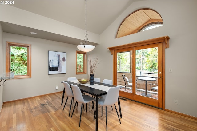 dining space featuring lofted ceiling and light wood-type flooring