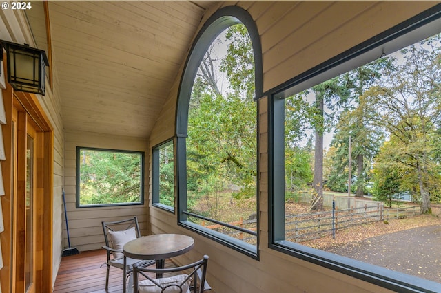 sunroom featuring vaulted ceiling