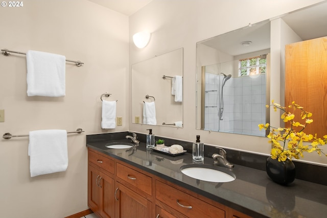 bathroom with vanity and tiled shower