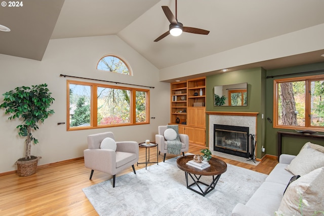 living room with light hardwood / wood-style flooring, ceiling fan, and vaulted ceiling