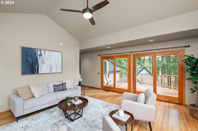 living room with light hardwood / wood-style flooring, lofted ceiling, and ceiling fan